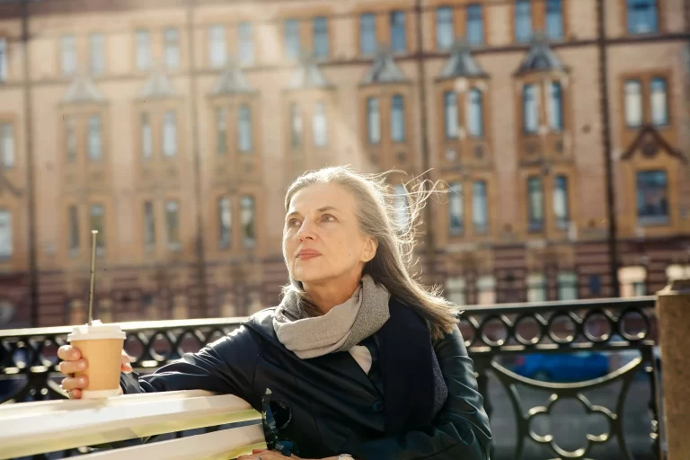 a women going though menopause sat on a bench
